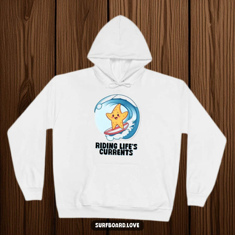 Funny hoodie with a cheerful starfish riding a wave on a tiny surfboard, offering warmth and a dose of humorous beachy fun.